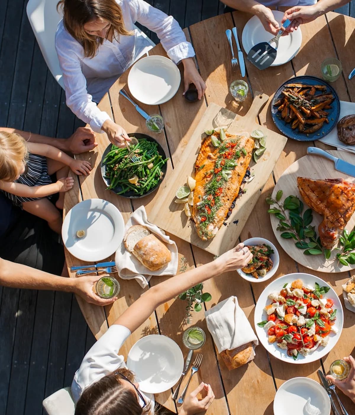 People sharing lunch around an outdoor table. Inspirational photograph.